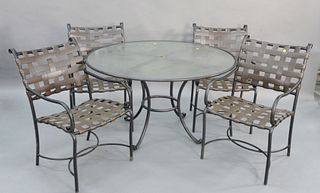 Five piece Brown & Jordan outdoor patio set to include round glass top table along with six armchairs and an umbrella ht. 28 1/2", dia. 48". Estate o