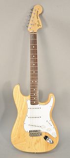 Fender Stratocaster guitar having neutral wood finish, made in 2000, serial #M20209265 along with hard case.