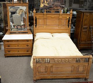 Two piece Eastlake Victorian bedroom set including marble top chest and mirror with candle shelves, three drawers and high back bed with spindle galle