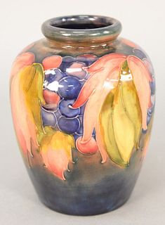 Moorcroft Pottery vase decorated with flowers and grapes, marked "Moorcroft Potter to the Queen" and remnants of paper label, 6 1/2". Provenance: The 