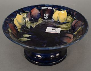 Moorcroft "Plum Wisteria" footed dish, signed "Moorcroft", stamped "Moorcroft Made in England" and Moorcroft label all to base, ht. 3 1/2", dia. 8 1/2