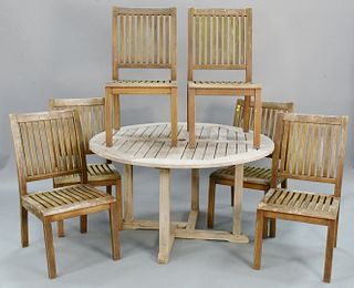 Seven piece outdoor teak set, includes: round dining table, ht. 28 1/2", dia. 51"; and six Barlow Tyrie chairs ht. 36 1/2", wd. 18 3/4", seat dp. 19 1
