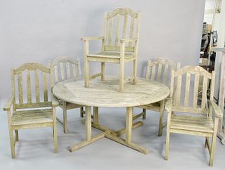 Seven piece teak outdoor patio set to include six chairs and round table by Wood Classics, NY.