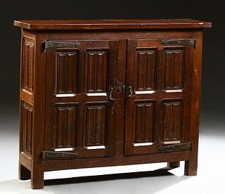 French Provincial Louis XIII Style Carved Oak Sideboard, 19th c., the rectangular top over double linenfold paneled doors with iron...