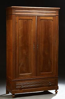 French Provincial Louis Philippe Carved Walnut and Beech Armoire, 19th c., the stepped crown over double paneled doors over a reeded...