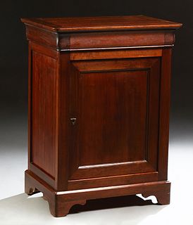 French Provincial Louse Philippe Carved Cherry Confiturier, 19th c., the rounded corner top over a frieze drawer and a cupboard door...