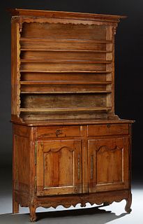 French Louis XV Style Carved Oak Vaisselier, 19th c., the stepped cavetto crown above three plate racks, on a plank top rounded corn...