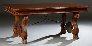 French Carved Walnut Renaissance Style Drawleaf Dining Table, early 20th c., the stepped carved edge top on large scrolled trestle b...
