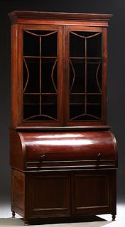 English Carved Mahogany Secretary Bookcase, 19th c., the stepped crown over double mullioned glazed doors, above a cylinder desk, op...