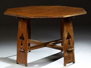 Limbert Style Caved Oak Octagonal Dining Table, late 20th c., on four wide flat legs with spade cutouts, joined by a flat X-form str...