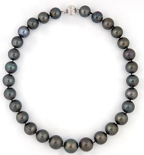 Graduated Strand of 29 Dark Grey Tahitian Cultured Pearls, ranging from 13-16 mm, with a 14K white gold ball clasp, L.- 17 in., with...