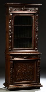 French Provincial Henri II Style Carved Oak Bookcase Cupboard, c. 1880, the stepped ogee crown over a glazed door flanked by relief...