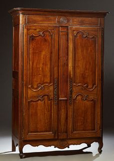 French Provincial Carved Walnut Louis XV Style Armoire, early 19th c., the stepped rounded corner crown over double doors with doubl...