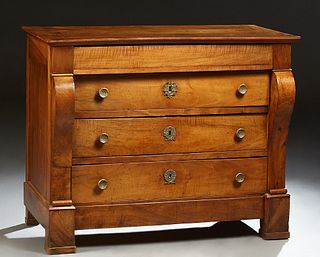 French Empire Style Carved Walnut Commode, c. 1840, the sloping edge rectangular top over a frieze drawer and three setback deep dra...