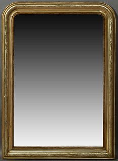 French Louis Philippe Gilt Pine Overmantel Mirror, 19th c., the wide arched frame with incised leaf and floral decoration, around a...