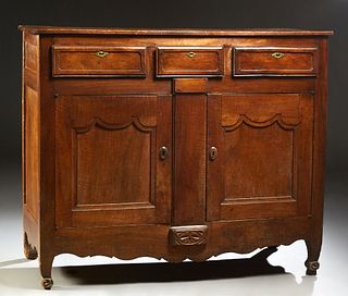 French Provincial Carved Walnut Louis XV Style Sideboard, early 19th c., the rectangular two board top over three frieze drawers wit...