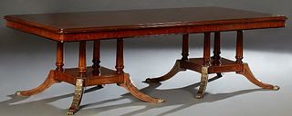 Empire Style Inlaid Walnut Dining Table, 20th c., the stepped rounded corner top on two gilt acanthus carved reeded column pedestals...