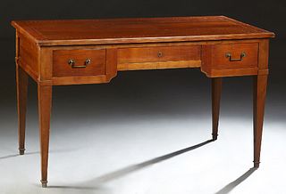 French Louis XVI Style Inlaid Cherry Desk, early 20th c., the stepped ogee edge top over a center frieze drawer flanked by two drawe...