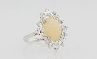 Lady's 14K White Gold Dinner Ring, with a 3.4 carat oval cabochon opal, within a border of round diamonds, total diamond weight- .37...