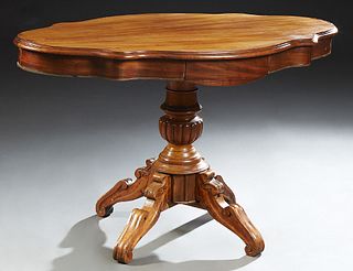 French Carved Walnut Center Table, c. 1870, the stepped tortoise top over a wide skirt with two side drawers, on a turned and reeded...