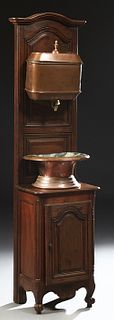 French Provincial Louis XV Style Copper and Brass Lavabo, early 20th c., the copper reservoir and basin on an arched carved walnut f...