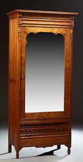 French Carved Pitch Pine Armoire, c. 1880, the stepped ogee crown over a single mirror door above a deep drawer, flanked by reeded p...