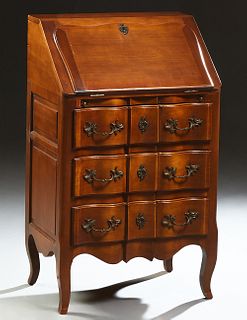 French Louis XV Style Carved Cherry Slant Front Desk, 20th c., the rectangular top over a slant lid with an inset gilt tooled writing..