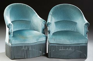 Pair of French Upholstered Barrel Back Armchairs, c. 1870, with an arched upholstered back and arms, above a bowed seat, on turned t...