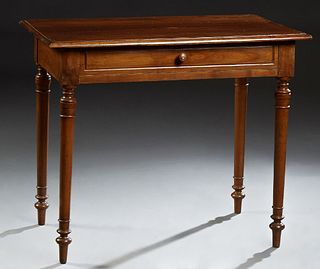 French Louis Philippe Carved Walnut Writing Table, 19th c., the stepped rounded edge top over a wide skirt with a frieze drawer, on...