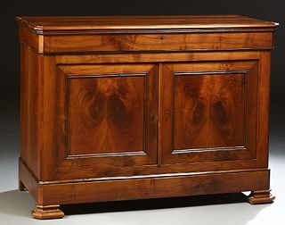 French Provincial Louis XV Style Carved Walnut Sideboard, c. 1860, the canted corner top over a long frieze drawer above double cupb...