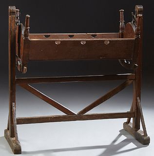 French Provincial Carved Cherry Cradle, 19th c., with turned posts and arched ends on two rocking feet, with applied iron rings, det...