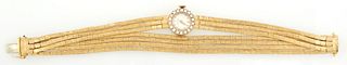 Lady's 14K Yellow Gold La Femme Dress Wristwatch, mid 20th c., with a diamond mounted bezel containing 18 three point round diamond,...