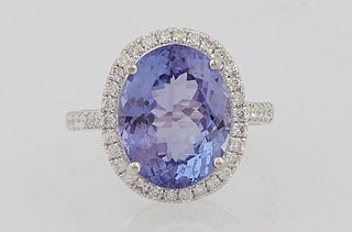 Lady's 14K White Gold Dinner Ring, with an oval 6.43 carat tanzanite atop a