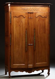 French Provincial Louis XV Style Carved Cherry Armoire, 19th c., the stepped canted corner crown over double paneled doors with bras...
