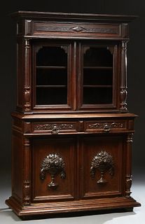French Henri II Style Carved Oak Buffet a Deux Corps, 19th c., the stepped edge crown over setback double glazed doors, flanked by t...