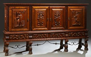French Carved Walnut Renaissance Style Sideboard, 20th c., the carved rounded edge rectangular top over double cupboard doors with h...