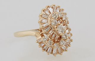 Lady's 18K Yellow Gold Dinner Ring, with a round diamond mounted "S", flanked by a graduated baguette mounted "S", size 8, total dia...