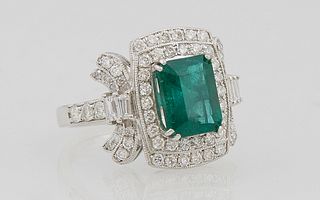 Lady's Platinum Dinner Ring, with a 2.65 carat emerald a top a conforming double graduated border of round diamonds flanked by diamo...