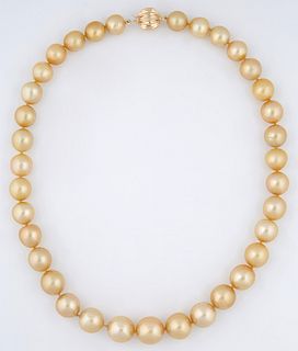 Graduated Strand of Thirty Five Tahitian Golden Cultured Pearls, ranging from 10-13 mm, with a 14K Yellow Gold ball clasp, L.- 17 1/...