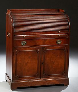 American Carved Mahogany Secretary, 20th c., the three-quartered gallery top over a tambour top fitted with cubby holes and drawer,...