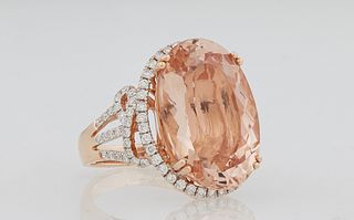 Lady's 14K Rose Gold Dinner Ring, with an oval 17.04 carat morganite, atop a border of small round diamonds flanked by diamond mount...
