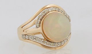 Lady's 14K Yellow Gold Dinner Ring, with a cabochon 4.18 carat opal, atop a swirled pierced band mounted with small round diamonds,...