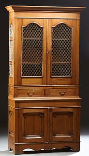 French Carved Cherry Buffet a Deux Corps, early 20th c., the stepped ogee crown over double arched doors with iron wirework grills,...