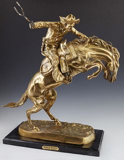 After Frederic Remington, "The Bronco Buster," 20th/21st c., gilt bronze figural group, on a figured black marble base, H.- 22 in.,...