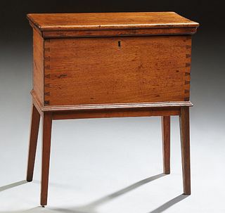American Southern Carved Mahogany Cellarette, late 19th c., the lifting rounded edge lid to a removable interior shelf, on tapered s...