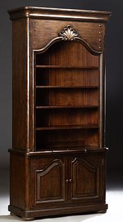 French Provincial Style Carved Mahogany Open Bookcase, 20th c., the stepped ogee crown over a shell carving and three adjustable she...