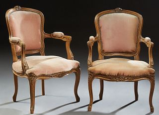 Pair of French Louis XV Style Upholstered Beech Fauteuils, 20th c., the floral carved crest above an upholstered shield shaped back,...