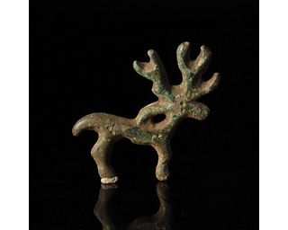 BRONZE AGE STAG FITTING OR AMULET