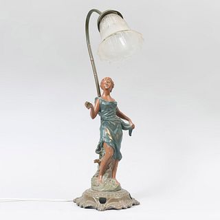 Lámpara de mesa, con dama. Origen europeo Siglo XX. Estilo Art Nouveau. Fundición en antimonio patinado con base de 4 puntos.