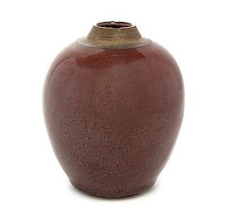 * A Red Glazed Pottery Jar Height 4 1/8 inches.
